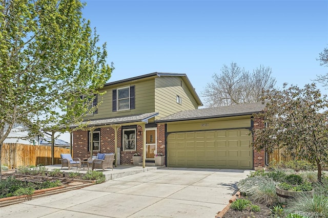 view of front of home featuring a garage, fence, brick siding, and concrete driveway