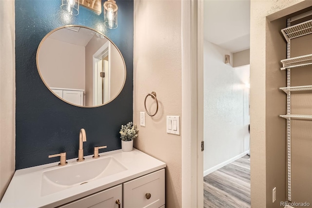 bathroom with vanity and wood finished floors