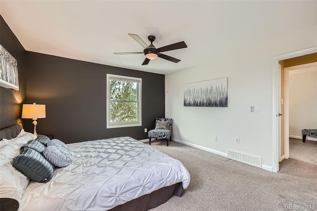 carpeted bedroom featuring baseboards and ceiling fan