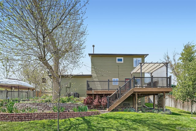 rear view of property with a deck, stairs, and a gazebo