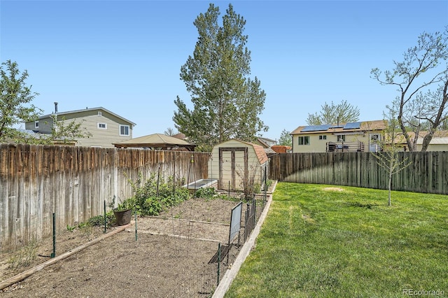 view of yard featuring a storage unit, a vegetable garden, and an outdoor structure