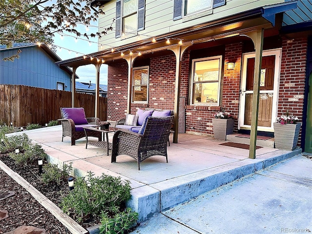 view of patio featuring fence and an outdoor hangout area