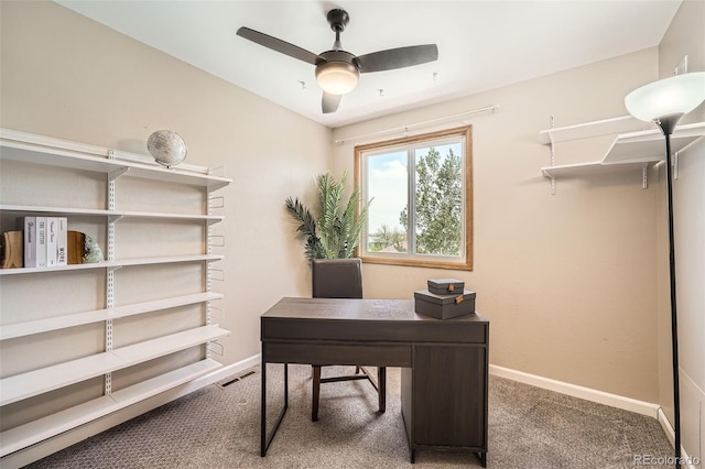 office area with carpet flooring, a ceiling fan, and baseboards