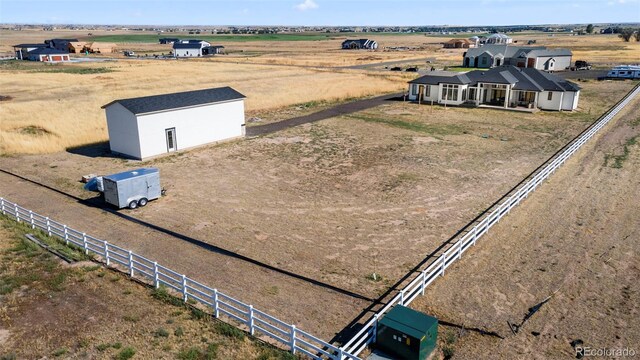 birds eye view of property with a rural view