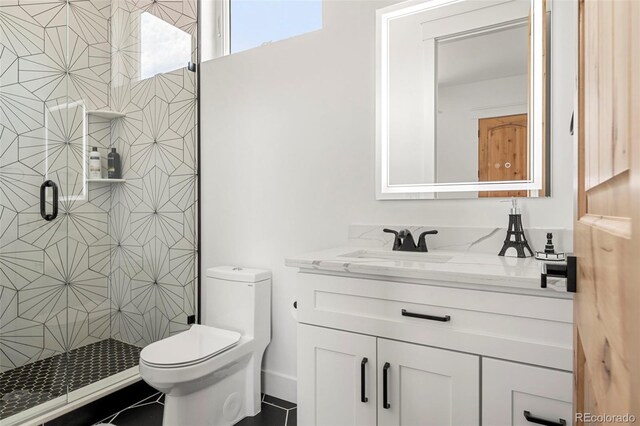 bathroom featuring toilet, tile patterned floors, vanity, and a shower with shower door