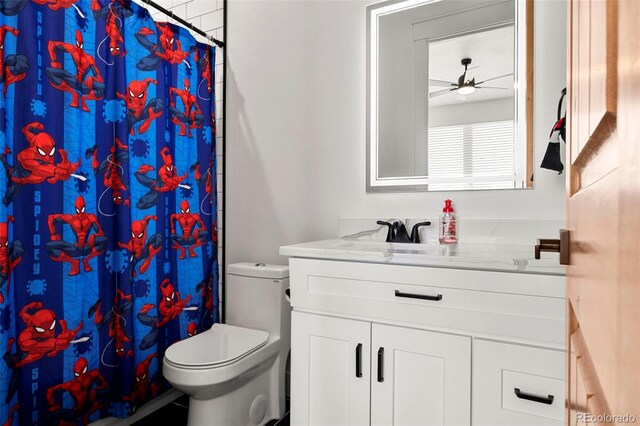 bathroom featuring toilet, vanity, and ceiling fan