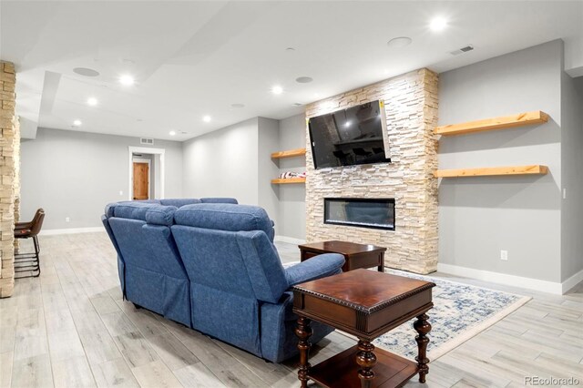 living room featuring a fireplace and light wood-type flooring