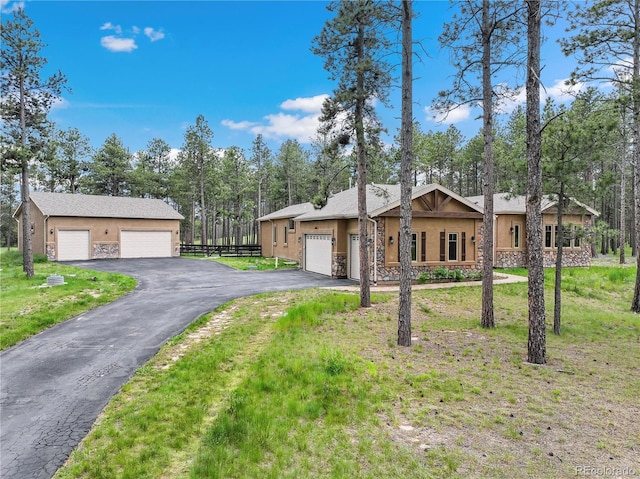16104 Pole Pine Pt, Colorado Springs, CO 80908 - single story home with stucco siding, stone siding, a detached garage, and asphalt driveway