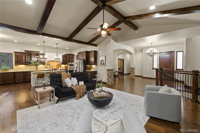 16104 Pole Pine Pt, Colorado Springs, CO 80908 - living area with a chandelier, arched walkways, dark wood-style floors, recessed lighting, and ceiling fan