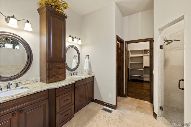 16104 Pole Pine Pt, Colorado Springs, CO 80908 - full bathroom with a shower stall, double vanity, and a walk in closet