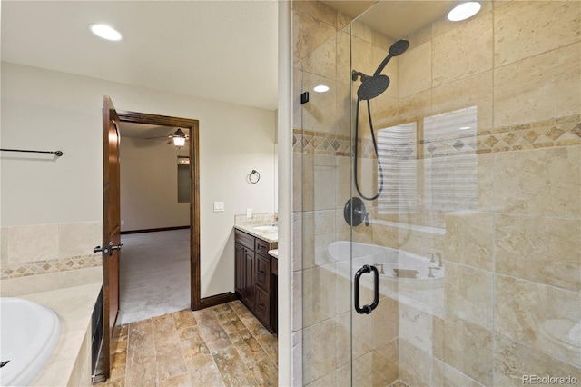 16104 Pole Pine Pt, Colorado Springs, CO 80908 - bathroom featuring a stall shower, vanity, a bath, ceiling fan, and recessed lighting