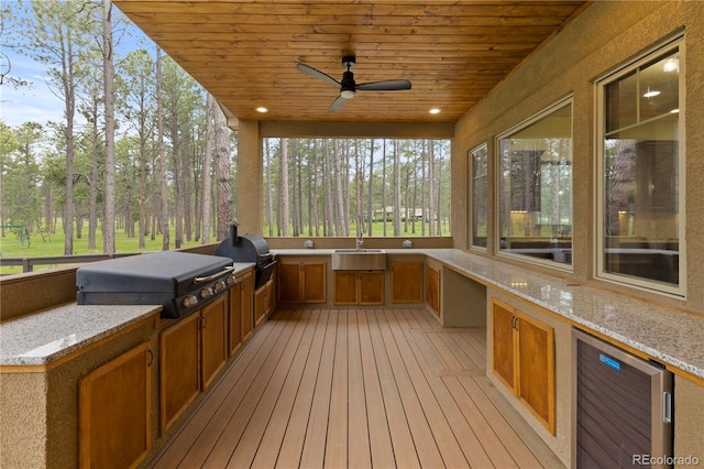 16104 Pole Pine Pt, Colorado Springs, CO 80908 - wooden terrace featuring exterior kitchen, ceiling fan, and beverage cooler