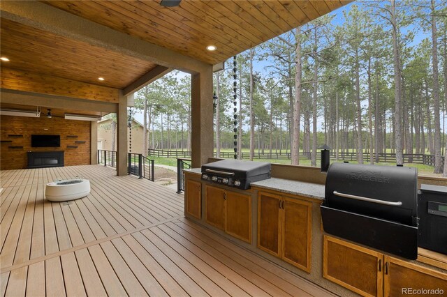 16104 Pole Pine Pt, Colorado Springs, CO 80908 - deck with exterior kitchen and view of wooded area