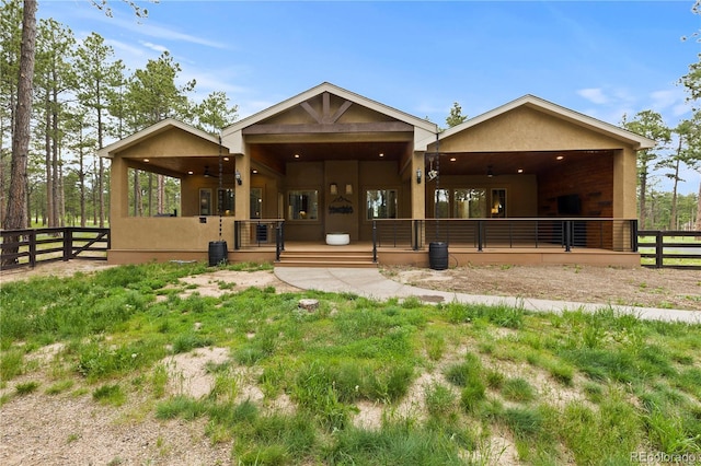 16104 Pole Pine Pt, Colorado Springs, CO 80908 - rear view of house featuring stucco siding and ceiling fan