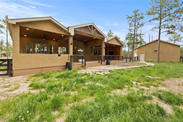 16104 Pole Pine Pt, Colorado Springs, CO 80908 - back of property featuring stucco siding and ceiling fan