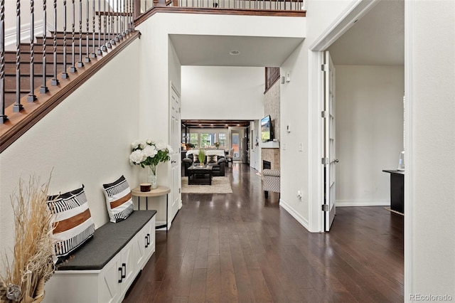8464 E 55th Pl, Denver, CO 80238 - entrance foyer featuring a high ceiling, dark wood-type flooring, baseboards, and stairway