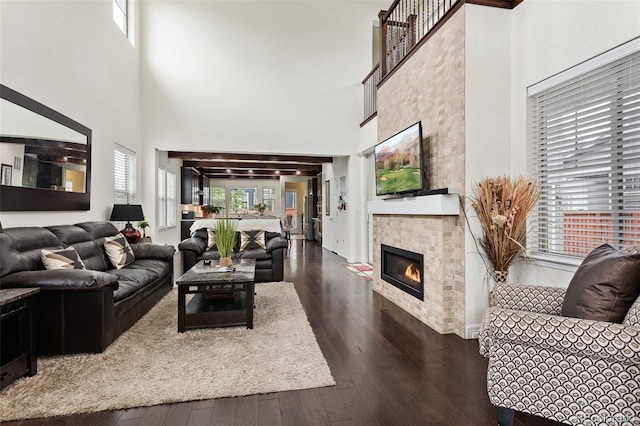 8464 E 55th Pl, Denver, CO 80238 - living area with a towering ceiling, wood-type flooring, and a fireplace