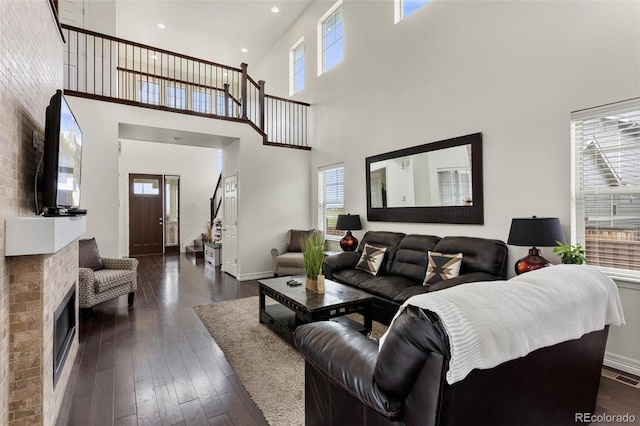 8464 E 55th Pl, Denver, CO 80238 - living area with a towering ceiling, dark wood-style flooring, recessed lighting, and baseboards