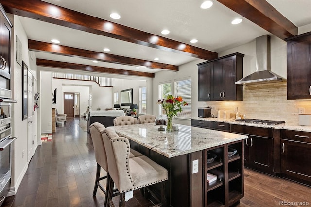8464 E 55th Pl, Denver, CO 80238 - kitchen with wall chimney exhaust hood, beam ceiling, tasteful backsplash, recessed lighting, and dark wood-style floors