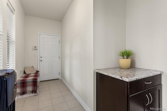 8464 E 55th Pl, Denver, CO 80238 - doorway to outside with light tile patterned floors, plenty of natural light, and baseboards