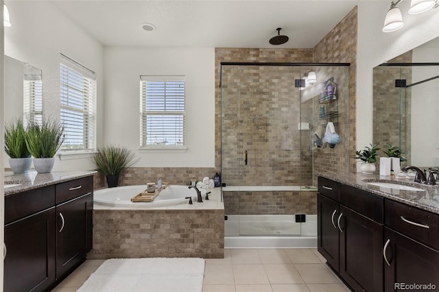 8464 E 55th Pl, Denver, CO 80238 - full bath featuring tile patterned flooring, a shower stall, vanity, and a bath