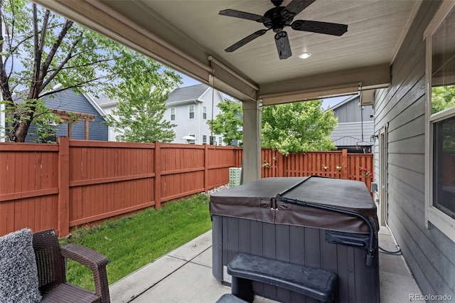 8464 E 55th Pl, Denver, CO 80238 - fenced backyard with a hot tub, a ceiling fan, and a patio area