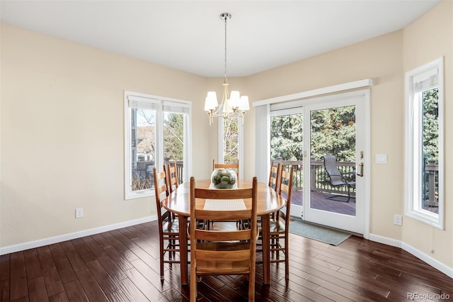 dining space with an inviting chandelier, baseboards, and dark wood-style flooring