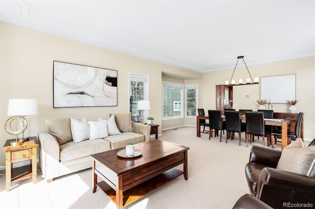 living room with baseboards, light colored carpet, and an inviting chandelier