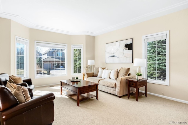 living room featuring baseboards, light carpet, and a healthy amount of sunlight