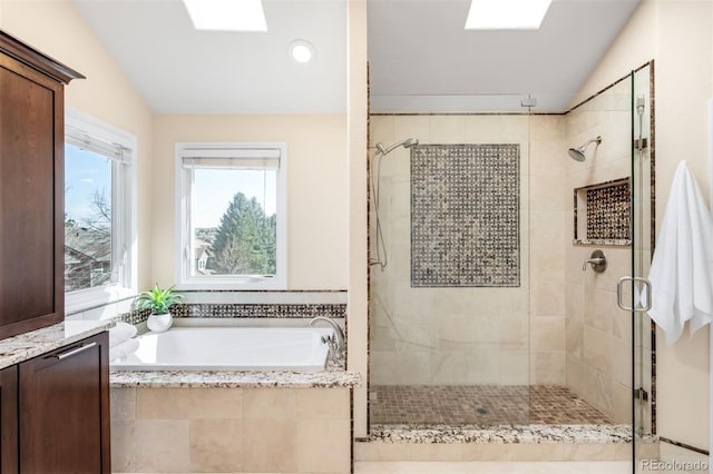 bathroom featuring lofted ceiling, a bath, and a shower stall