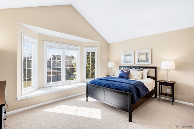 bedroom featuring lofted ceiling, baseboards, and carpet floors