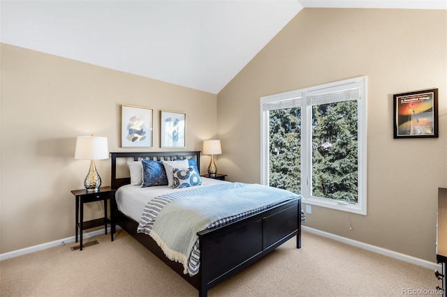 bedroom featuring visible vents, lofted ceiling, light colored carpet, and baseboards