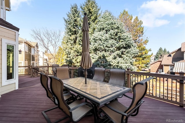 wooden terrace featuring outdoor dining area