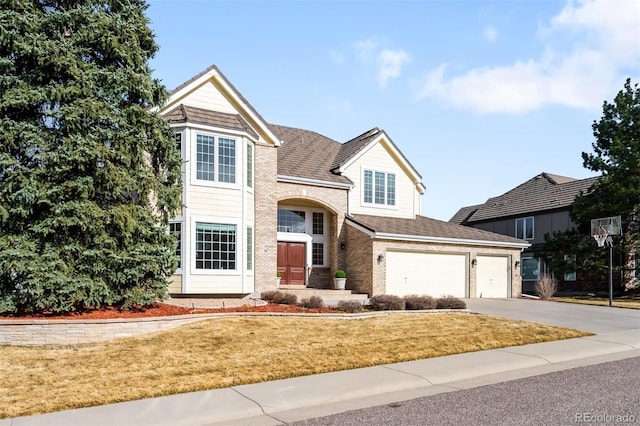 view of front of home featuring concrete driveway, brick siding, a front lawn, and a shingled roof