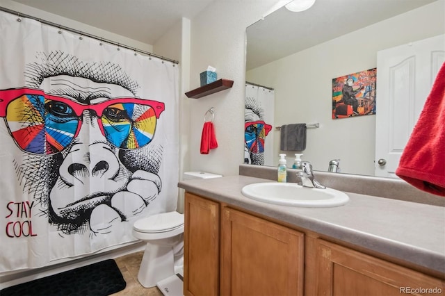 bathroom with tile patterned floors, vanity, and toilet