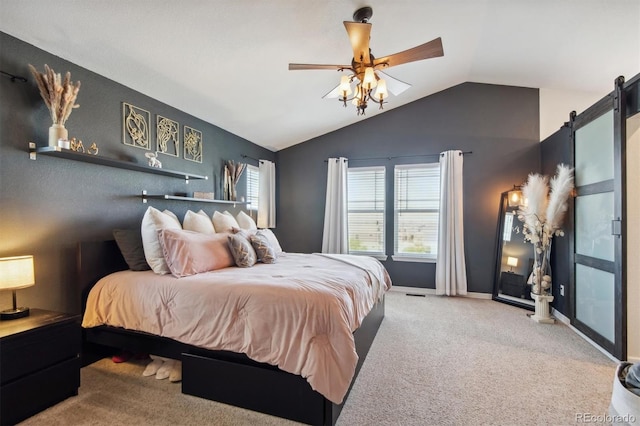 carpeted bedroom with ceiling fan, a barn door, and lofted ceiling