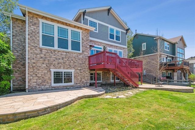 back of house with a yard, a deck, and a patio area