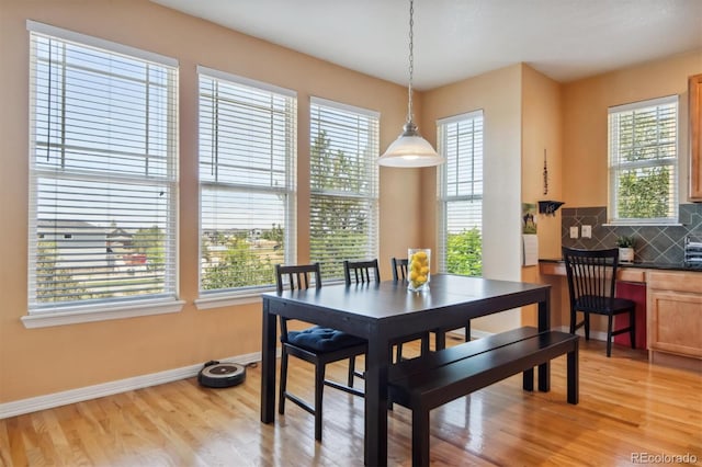 dining space with light hardwood / wood-style floors