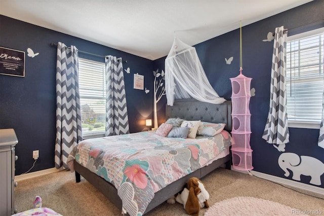 carpeted bedroom with multiple windows