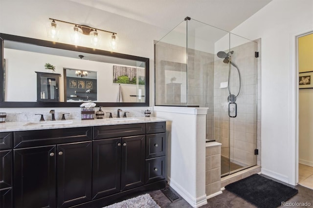 bathroom featuring tile patterned floors, vanity, and a shower with door