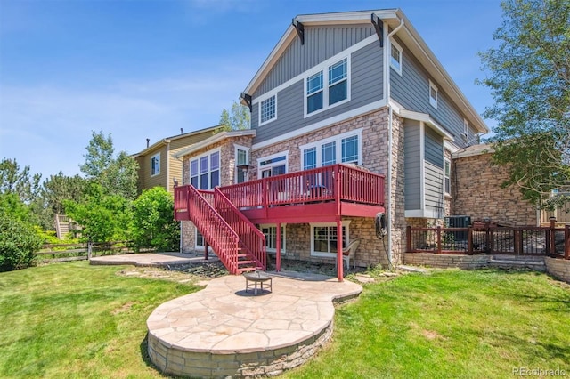 back of house with a patio area, a yard, a fire pit, and a deck