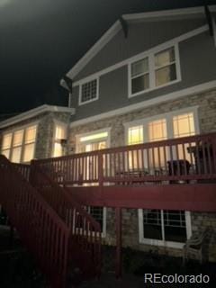 back house at night with a wooden deck