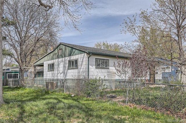 view of property exterior featuring roof with shingles and fence