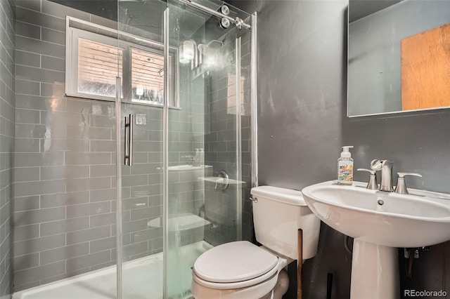 full bathroom with toilet and a shower stall