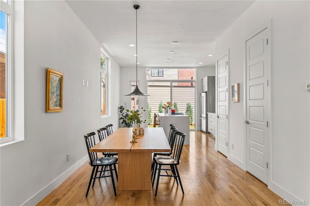 dining area featuring recessed lighting, baseboards, and light wood-style floors