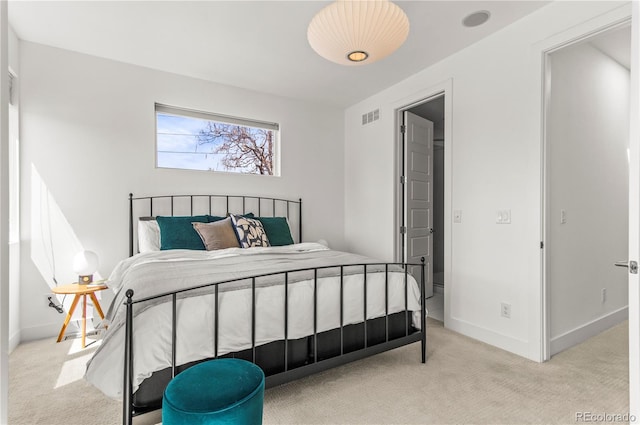 bedroom with light colored carpet, visible vents, and baseboards