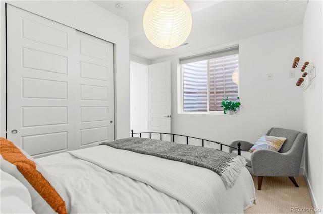 bedroom featuring carpet flooring, a closet, and baseboards