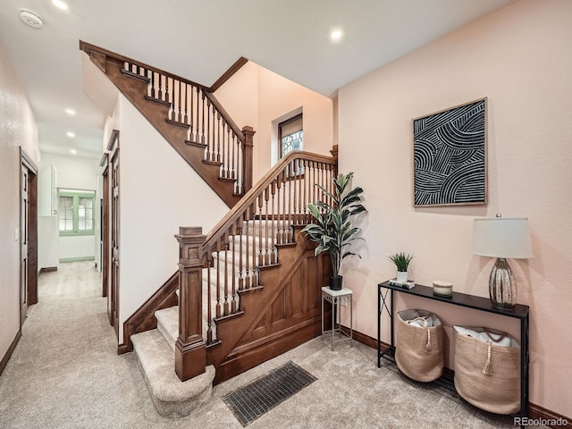 stairs with carpet, visible vents, plenty of natural light, and recessed lighting