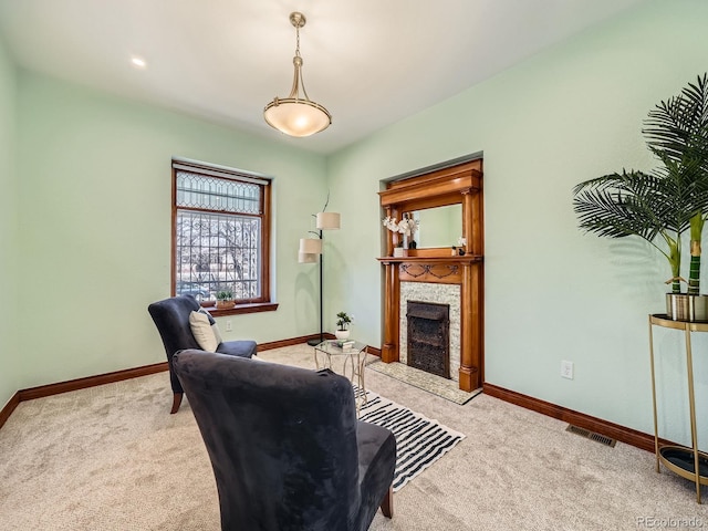 carpeted home office featuring a stone fireplace, visible vents, and baseboards