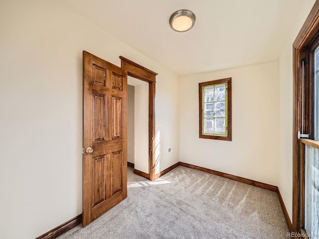 unfurnished bedroom with baseboards and light colored carpet